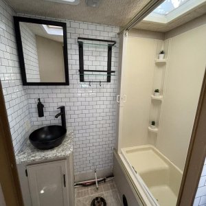 Original bathroom countertop had been ruined by a leaking hairspray bottle - so replaced countertop and sink - vessel mount was a way of being able to