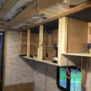 Building overhead kitchen cabinets. No microwave here.