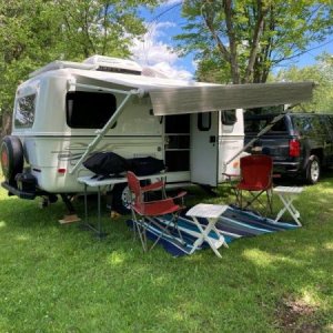 The manual awning allows one corner to be dipped down so any rain or dew runs off to one end. The griddle and BBQ are ready for breakfast. The coffee 