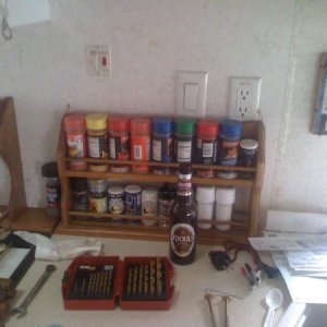 My extra large spice rack attached to wall by stove.