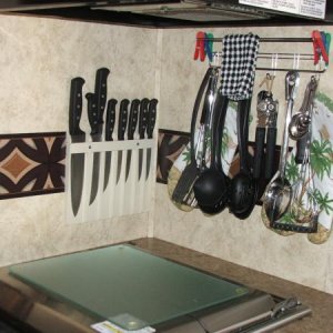 Knife holder (campers world) and hooks (not sure where I got this)for spatula, big spoons, etc. Added a clear cutting board to stove top to use and he