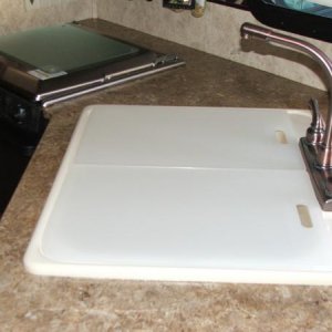 Two cutting boards my husband trimmed down to fit my sink so I could have two on sink instead of the big one that came with it.