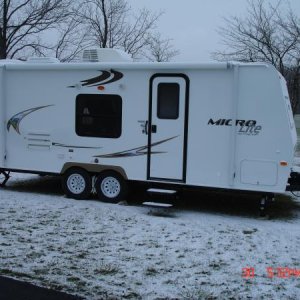 Side view. 2 step entry with 14 inch tires and aluminum lug covers