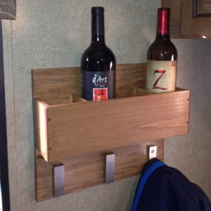 Closeup of custom 4 bottle wine rack and coat rack.