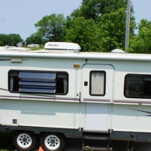 side of Pop Tart... awning, skylight, AC, vents, outdoor shower with pull down shelf with electric outlet for radio, etc.