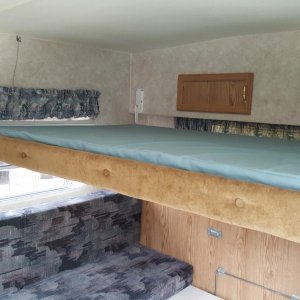 Upper bunk over large table (converts to Queen bed)