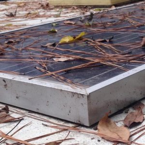 bracket to hold the panel to the roof on previous camper.  bracket is taped with VHB tape, panel bolted to that.