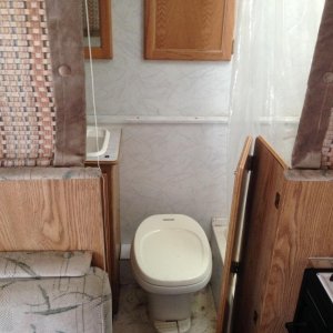 toilet, bath sink, shower, sloset all in bathroom, extra storage cabinets.