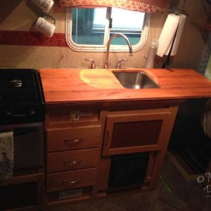 I made a larger counter that fits on top of the original counter. It's a little longer and has a cut out for one side of the sink, making the counter 