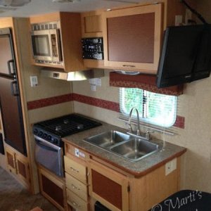 The trailer had had very little done to it in six years. 
 I attached a paper towel holder to the wall and command hooks beside the stove for coffee c