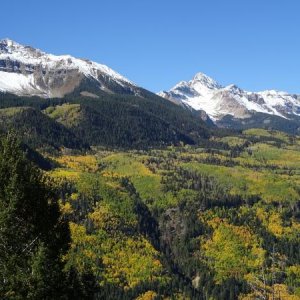 The San Juan Skyway between Dolores and Telluride, Colorado when the fall colors are at their peak. A recent snowfall in the mountains helped to compl