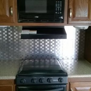 Stainless steel kitchen back splash.