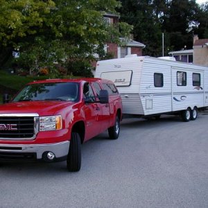 The new 2009 GMC 2500HD and 2000 Jayco Eagle 266 FBS parked in the cul-de-sec in front of the house.