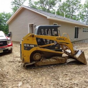 House, Truck and Gehl track loader (with broken track) in the upper parking area.