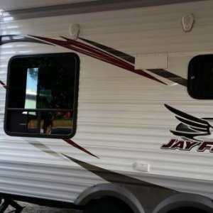 A side/rear shot of the Jayco. I love to sit and stare at the crooked outlet on the side. I hate that flap for the exhaust vent. It's my next project 