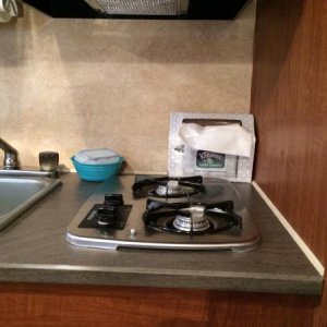 We usually have bar soap and the sink stopper in this bowl near the sink.  Toothbrushes and paste store in a large drinking glass here as well when pa