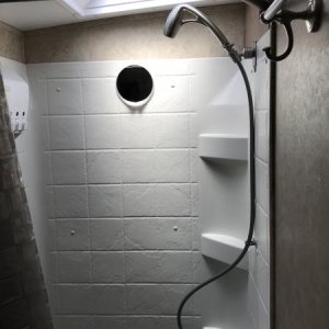 Oygenics shower head and Extend-a-Shower shower curtain rod. Both make for a much nicer shower experience.