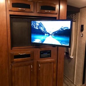 I installed an articulating mount inside Jayco's "lazy Susan" swiveling TV cabinet. Now we can actually watch TV from the sofa.