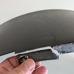 fatigued piece that has separated from fender