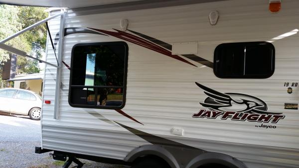 A side/rear shot of the Jayco. I love to sit and stare at the crooked outlet on the side. I hate that flap for the exhaust vent. It's my next project 