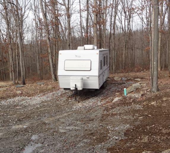 At last... At Home.  The Jayco Eagle 266 FBS arrives at the home base.  It lived at a nearby campground for over a year while the house was constructe