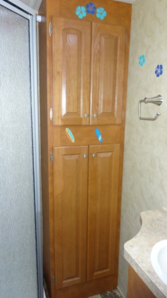 Bathroom sink on the right, cabinet straight ahead, and shower on the left.