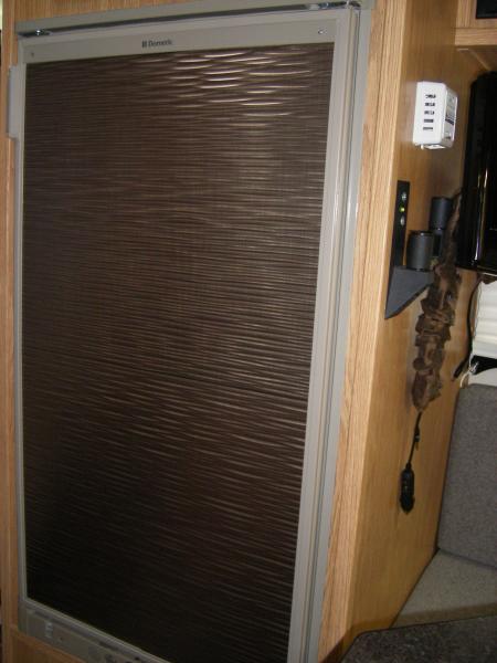 Covered over wood-look Fridge door panel with Fasade "Ripples" panel. Available at Home Depot & Lowes - see fasadeideas.com