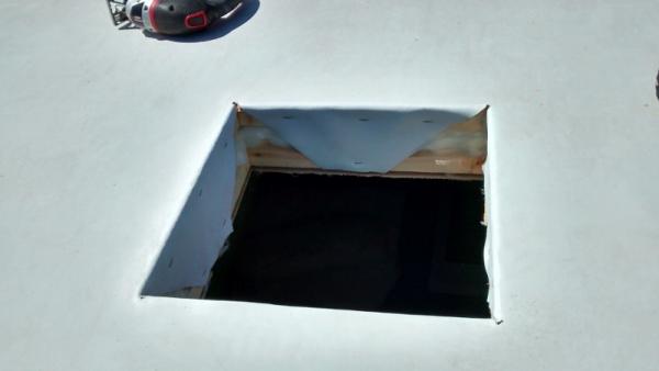 Cut hole in roof and folded EPDM material into hole.