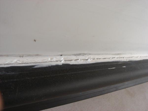 Dealer used lapsealant to caulk new bulb seal, already cracking