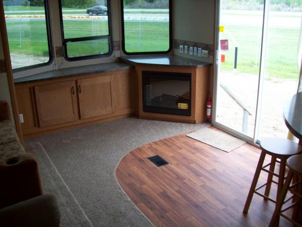 Front bay windows, fireplace, entertainment area, patio doors, and the stools for the breakfast area.