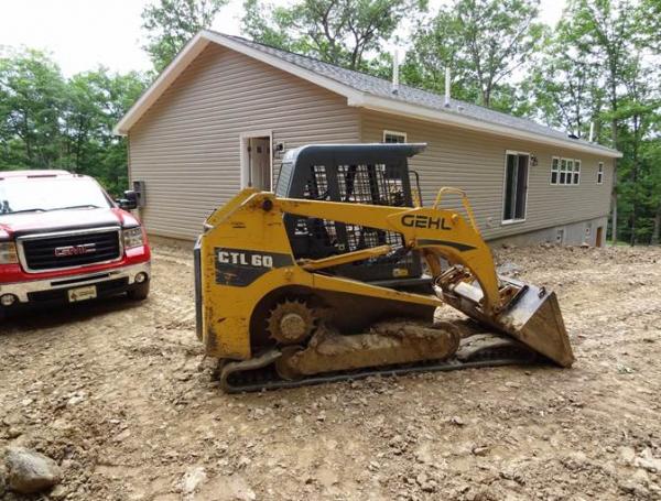 House, Truck and Gehl track loader (with broken track) in the upper parking area.