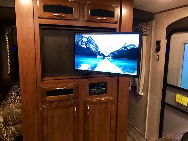 I installed an articulating mount inside Jayco's "lazy Susan" swiveling TV cabinet. Now we can actually watch TV from the sofa.