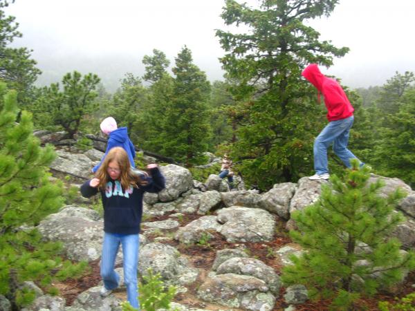 Kids having fun playing on the rocks in the camp ground