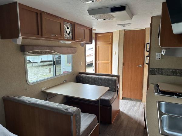 Large closet just inside door. Bathroom in rear corner. Dinette converts to extra bed and has storage under both seats. Cabinet over dinette — the end