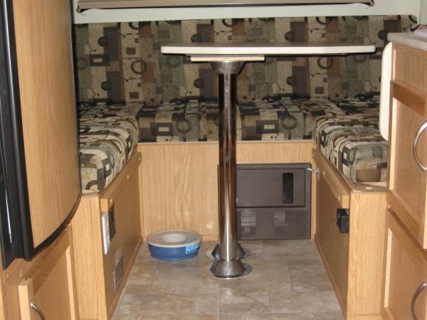 More Room Passenger Side with the smaller front dinette table at the rear.