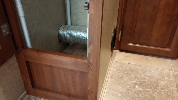 Moved the vent from under the shower and put it through the wardrobe out the side by the back bed.