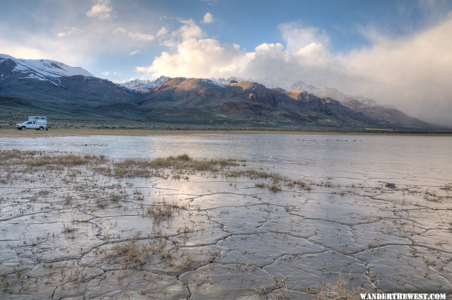 My rig between wet Alvord mud and snowy/cloudy Steens Mt.