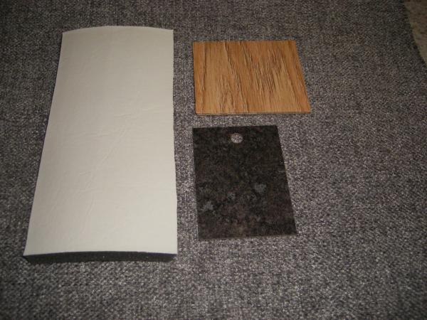 Neutral palette scheme visually enlarges the interior / grey heather fabric for seating areas & mineral jet radiance laminate for counters.  I provide