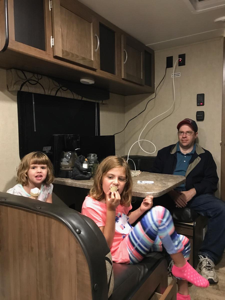 Noelle and Nora enjoying their first ice cream cones in the camper