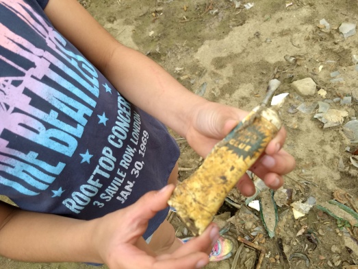 Old glue bottle from exposed dump