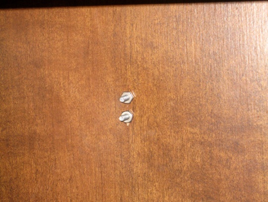 pantry interior closeup showing kitchen towel ring bolts