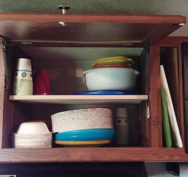 Put in adjustable shelf in cabinet above stove. Also removed panel between cabinet and microwave and fits my cutting boards perfectly.