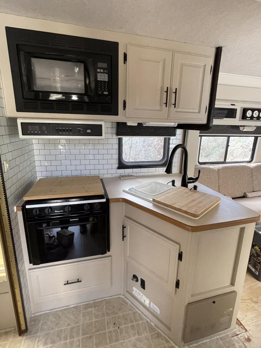 restored kitchen sink in place, new faucet and soap dispensers and cabinet hardware....really taking shape