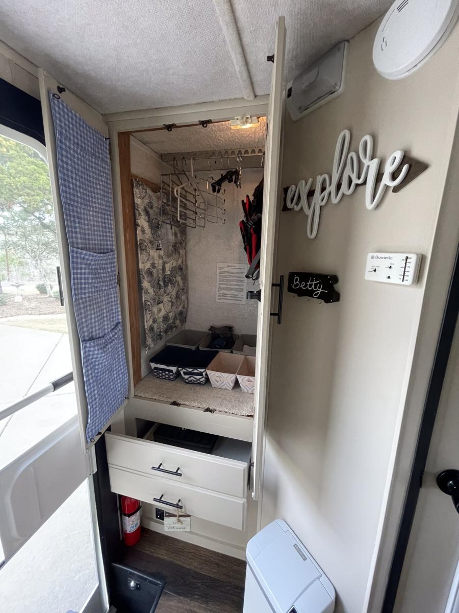 Roomy closet organized with more vertical storage including hanging laundry hamper.
I combined the 2 shallow drawers to make one deep one and we keep 