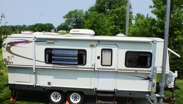 side of Pop Tart... awning, skylight, AC, vents, outdoor shower with pull down shelf with electric outlet for radio, etc.