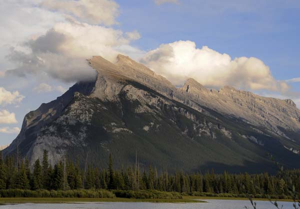 Snow and fog blowing across the ridge of a mountain outside of Banff.