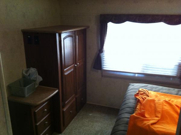 The master bedroom in the rear of the trailer with a slide out and tons of storage.  This is what sold us on this trailer. No traditional trailers had