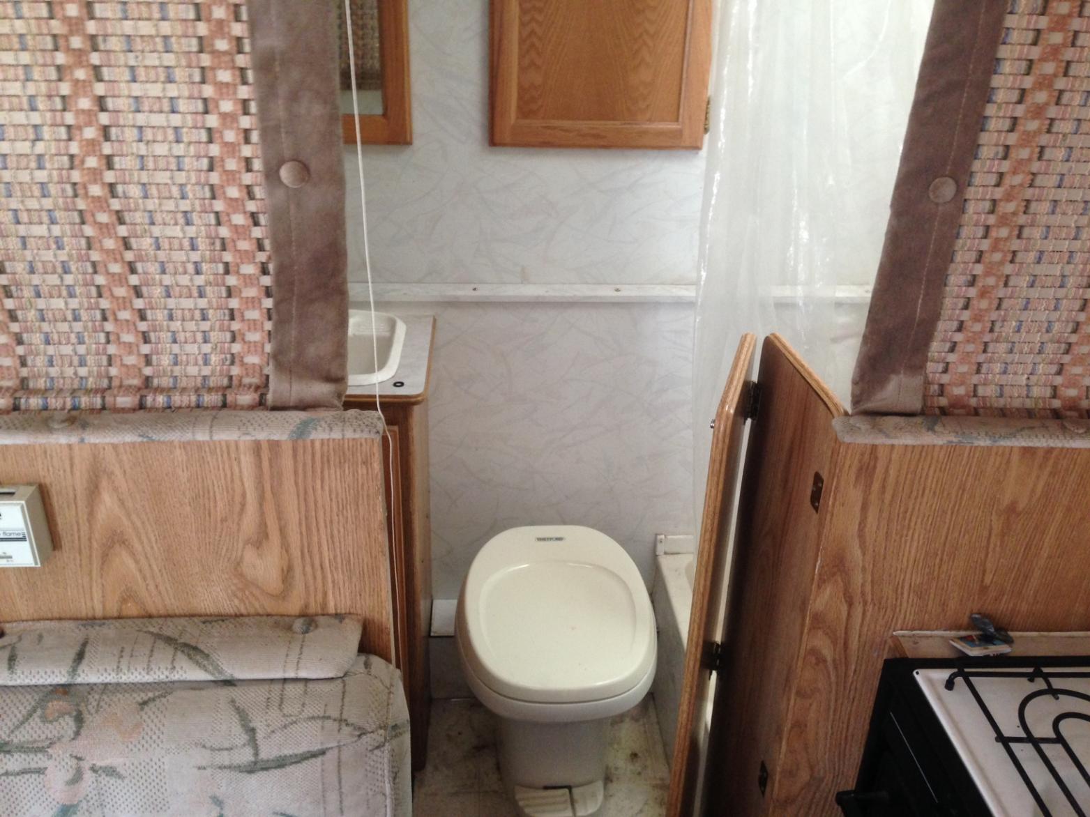 toilet, bath sink, shower, sloset all in bathroom, extra storage cabinets.