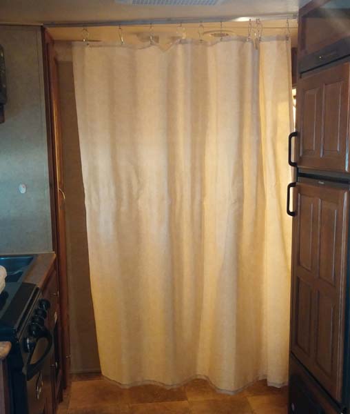 Took the shower curtain out of the bathroom (because we never shower in the Roo) and mounted it in front of the bathroom so we have a private changing