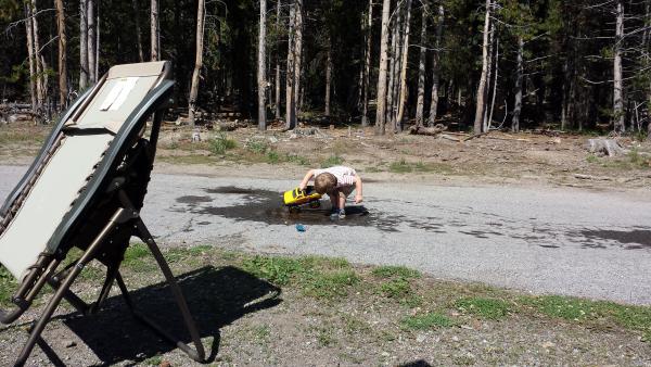 What more does a boy need than a truck and a mud puddle